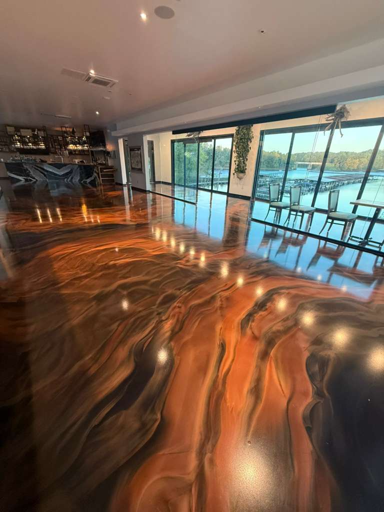 Amber Lava metallic epoxy floor in a lakefront great room